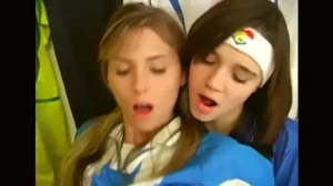 Girls from argentina and italy football uniforms have a nice time at the locker room